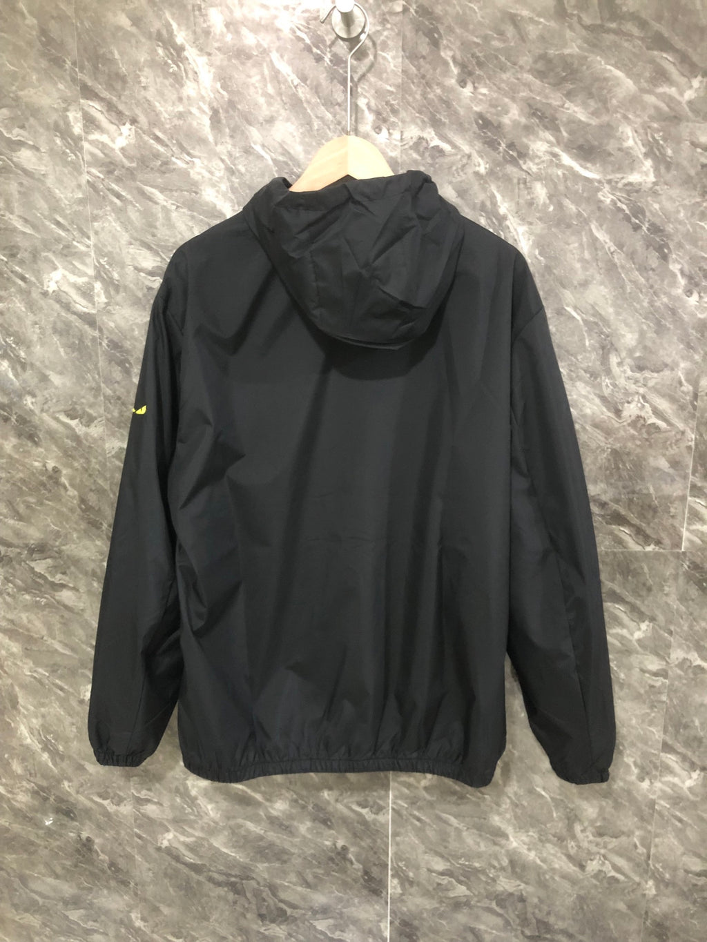 Hooded windbreaker jacket, dark fabric, full back view with zipper