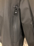 Windbreaker jacket zipper pull, dark fabric with stitched label holder