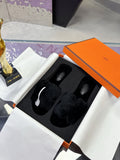 Hermes black faux-fur slide sandals with two wide cushioned crossover straps