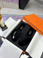 Hermes black faux-fur slide sandals with two wide cushioned crossover straps