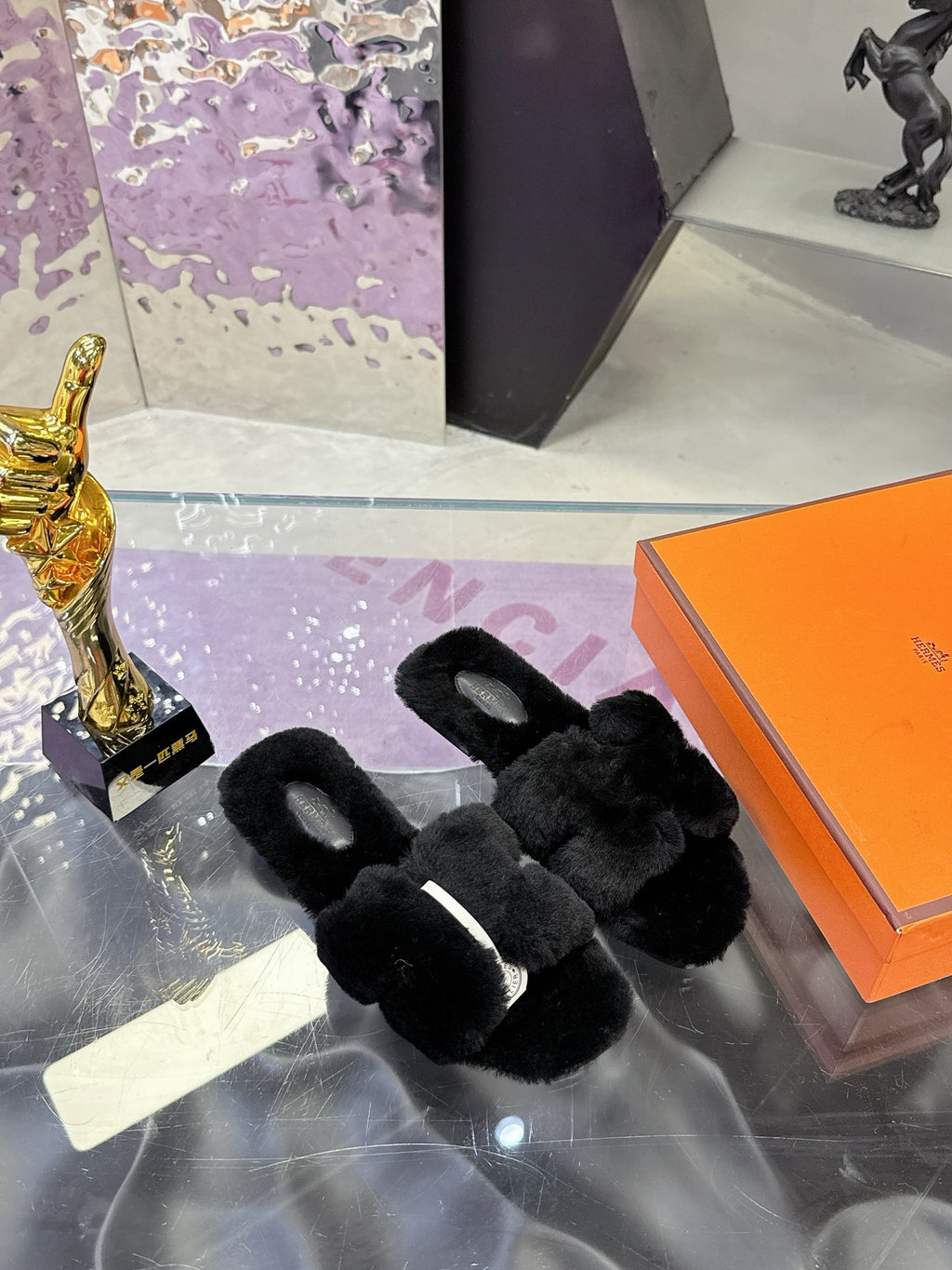 Hermes black faux-fur slide sandals with open toe and rounded strap edges