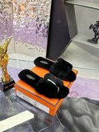 Hermes black faux-fur slide sandals with thick straps and open toe