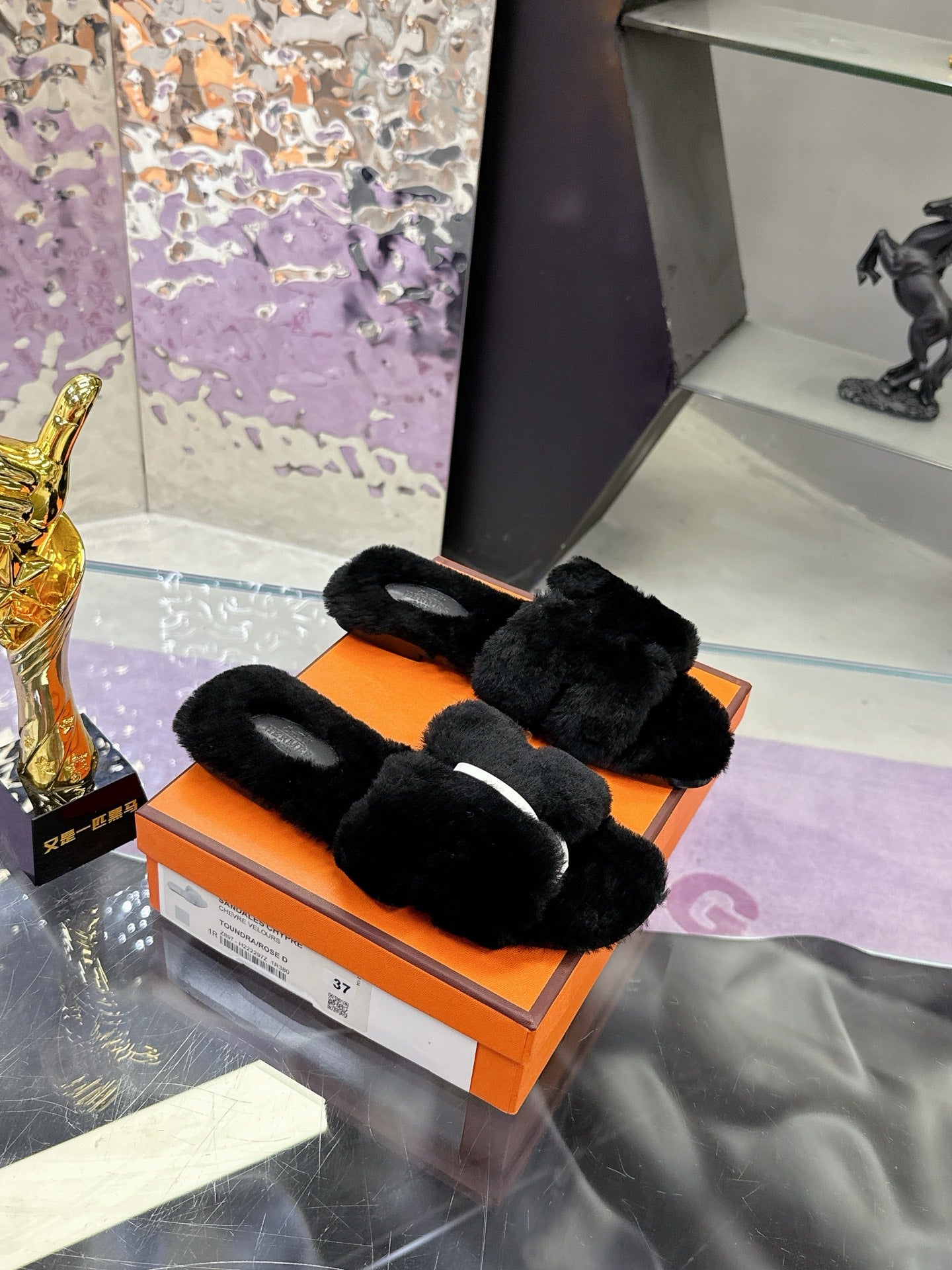 Hermes black faux-fur slide sandals with thick straps and open toe