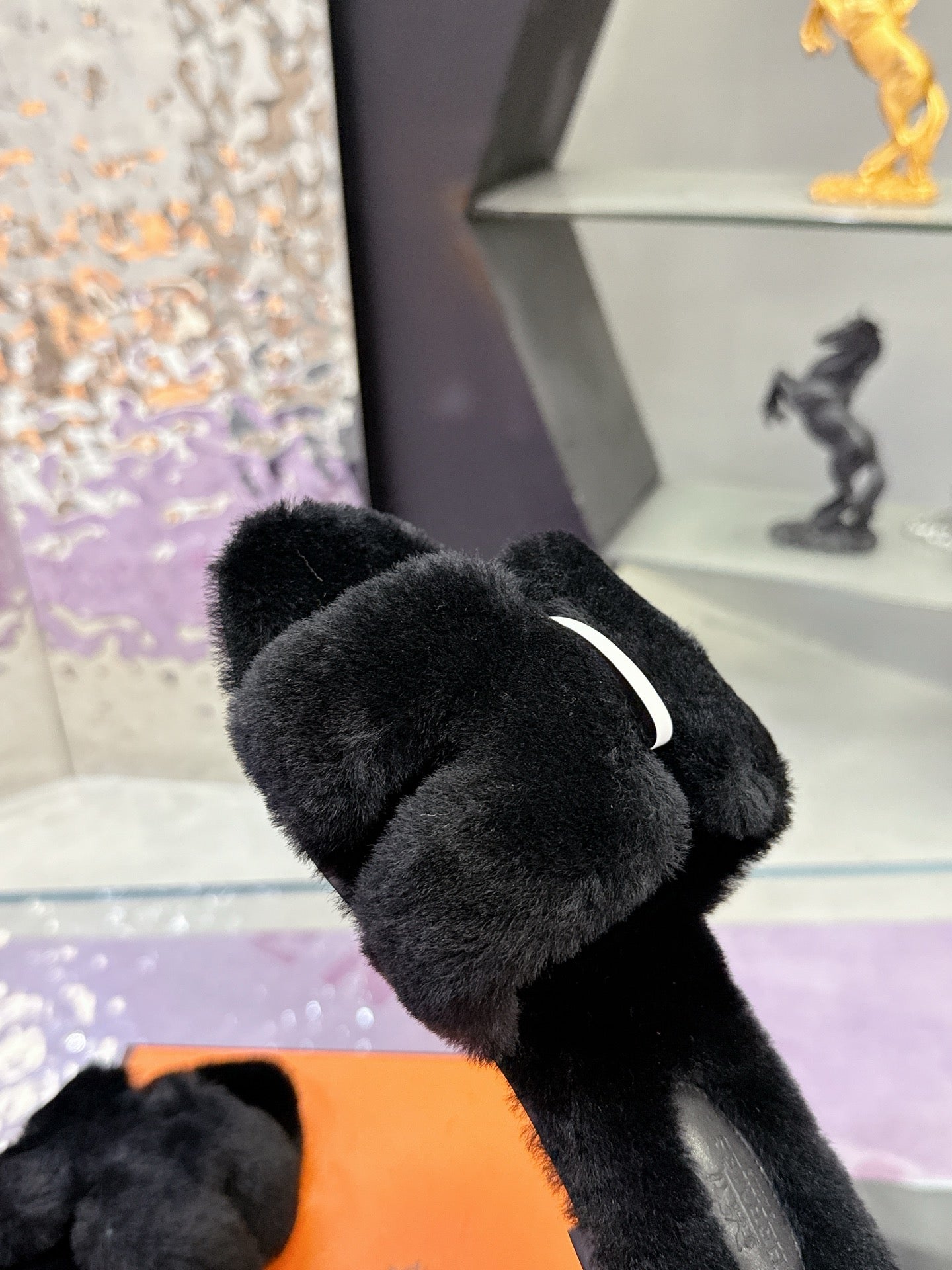 Hermes black faux-fur slide sandals with cushioned strap and curved toe opening