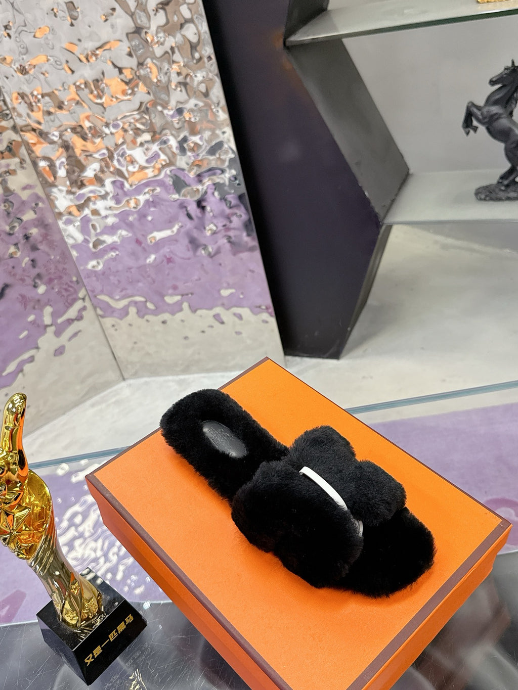 Hermes black faux-fur slide sandals with cushioned strap and open toe