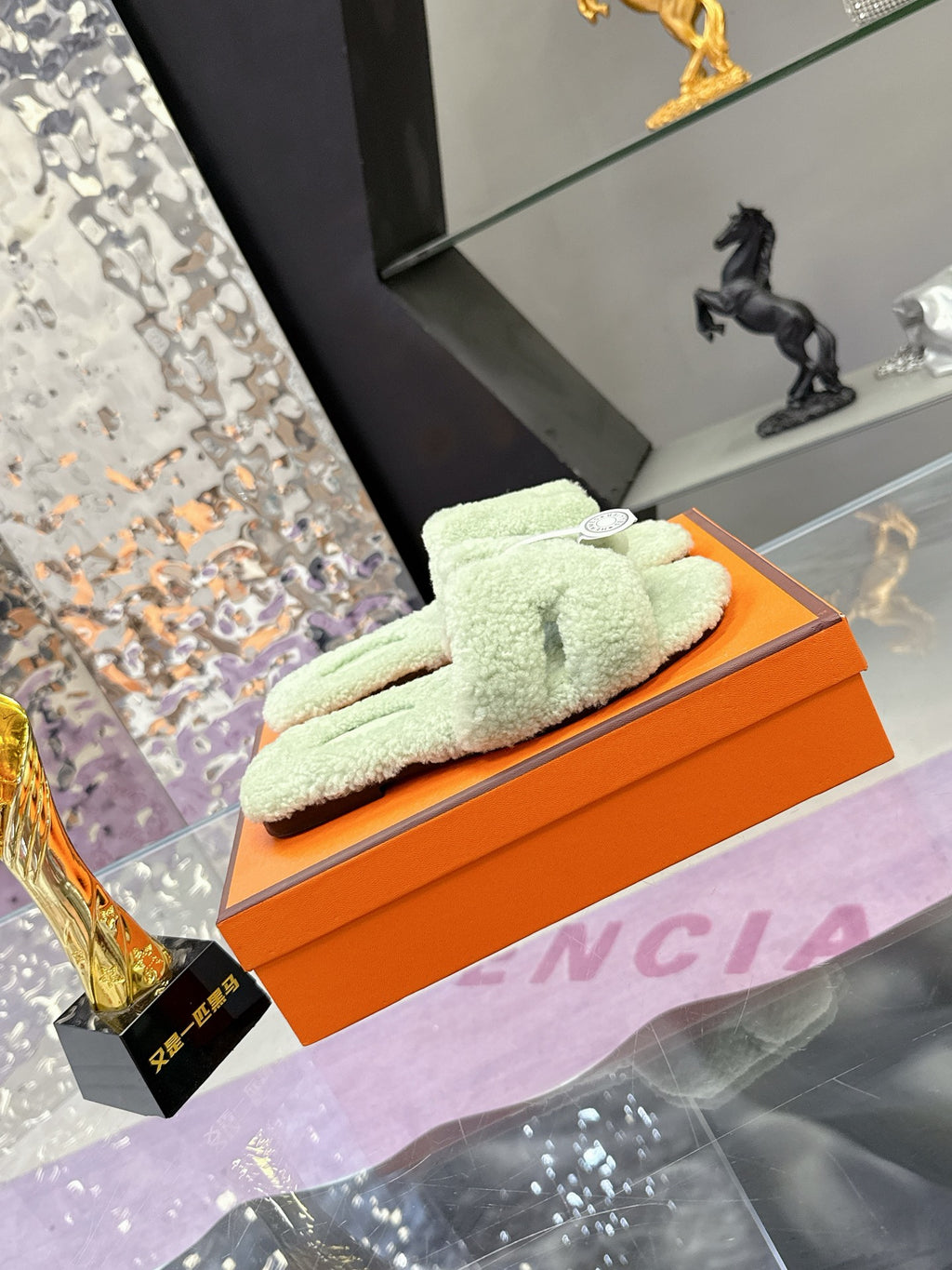 Mint green fuzzy slide sandals with black outsole and decorative strap