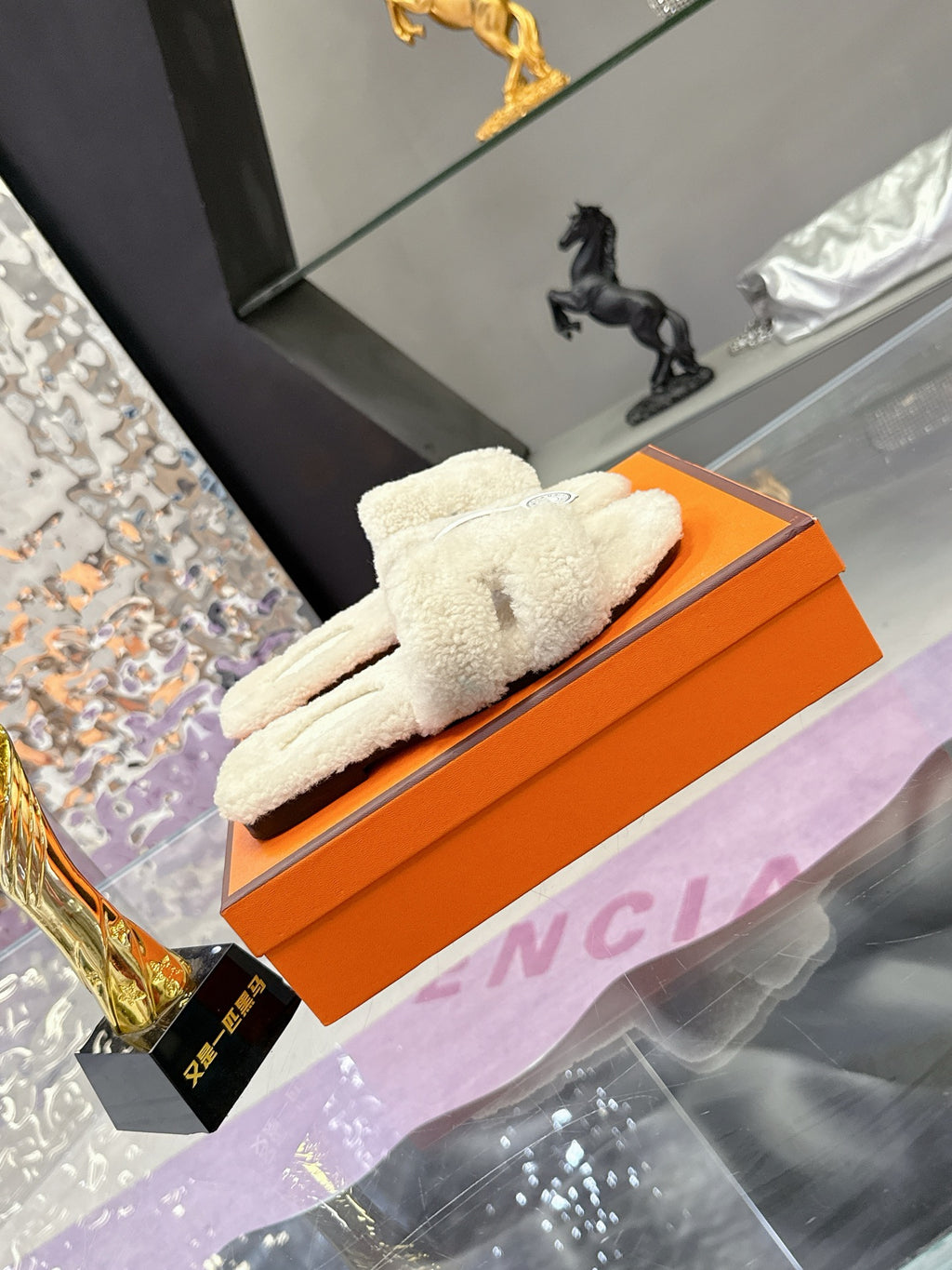 Hermes ladies cream shearling slides on orange box, single pair laid diagonally