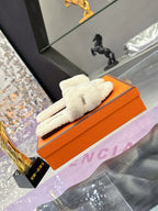Hermes ladies cream shearling slides on orange box, single pair laid diagonally