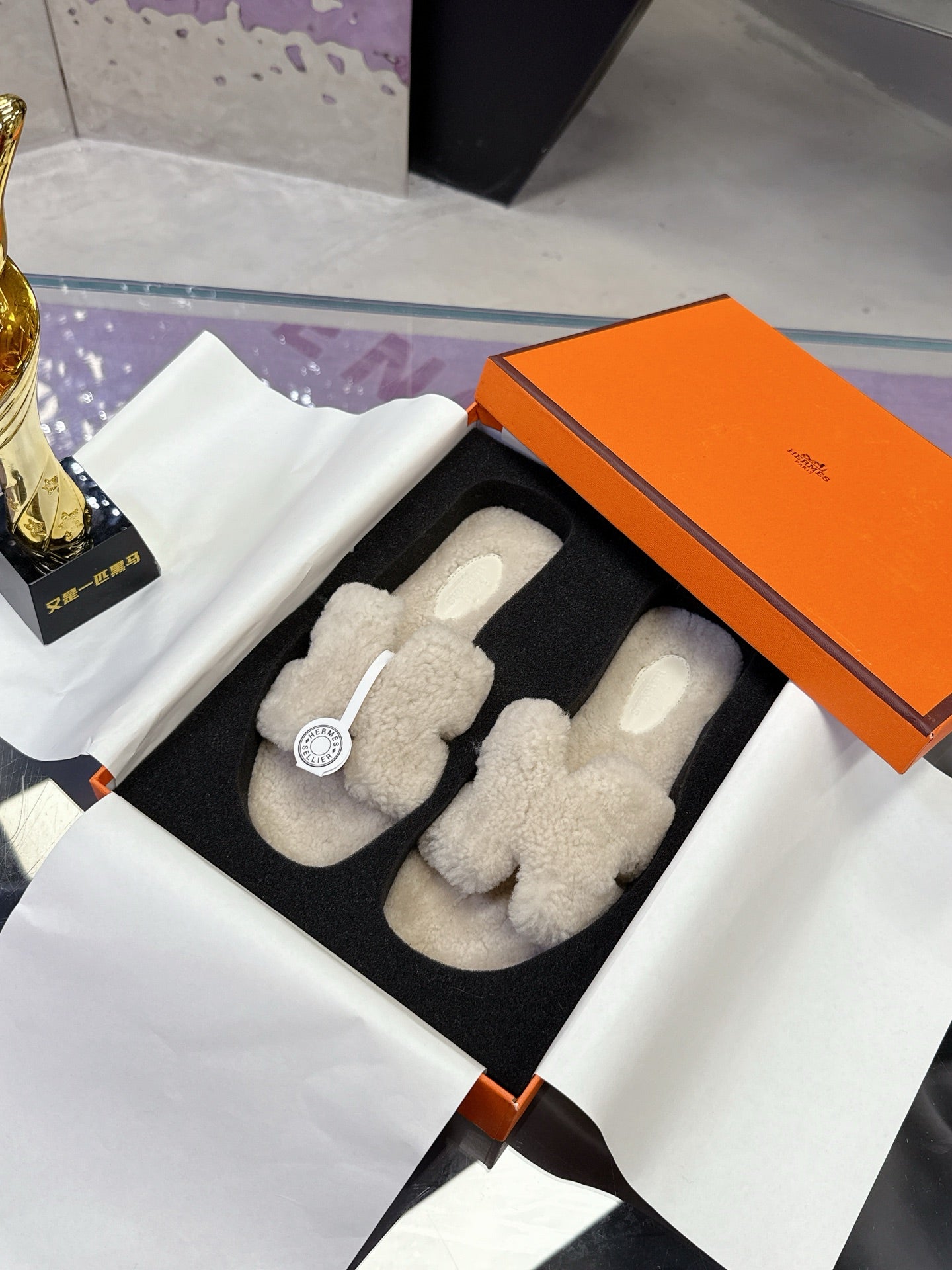 Hermes ladies shearling slides, cream fuzzy pair with circular logo patch