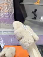 Hermes ladies shearling slide close-up, cream fuzzy upper with circular logo patch
