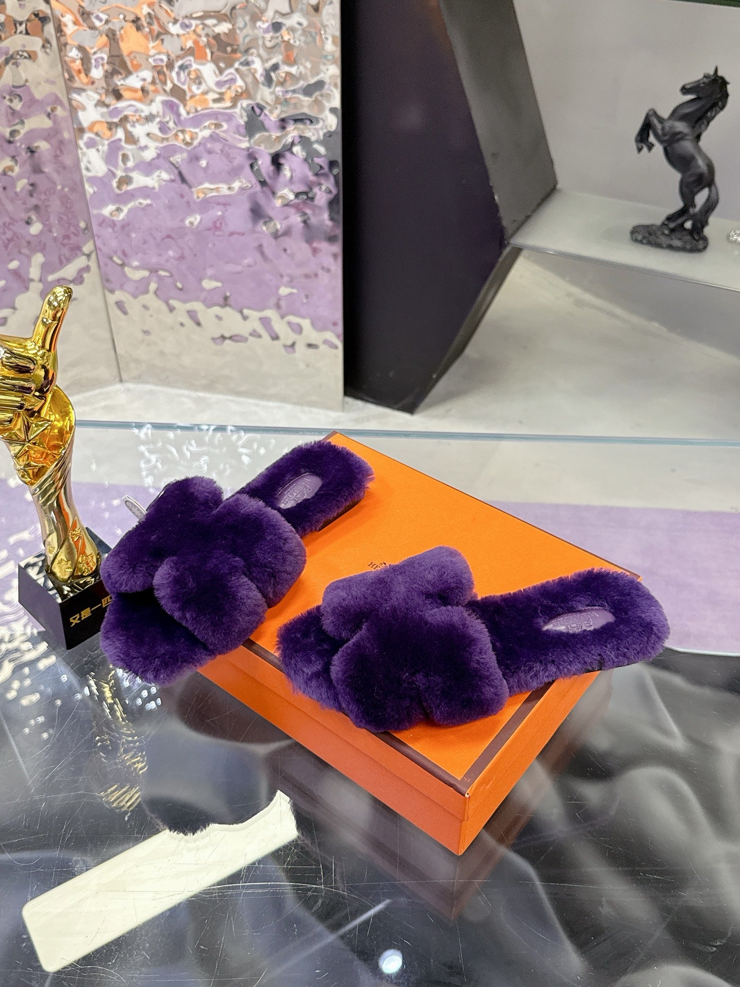 Hermes ladies purple faux-fur slides with bow strap, close view on orange box