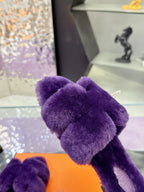 Hermes ladies purple faux-fur slide with bow strap, close-up on orange box