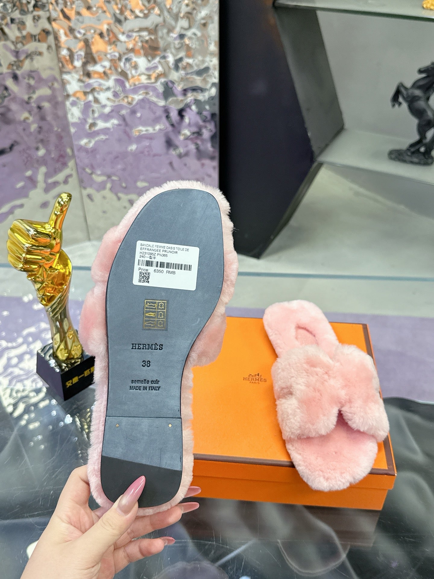 Slide sandal outsole, light pink faux-fur footbed with size label visible