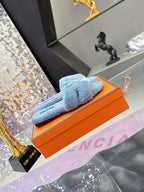 Hermes light blue plush slide sandals with white strap and round silver-tone emblem