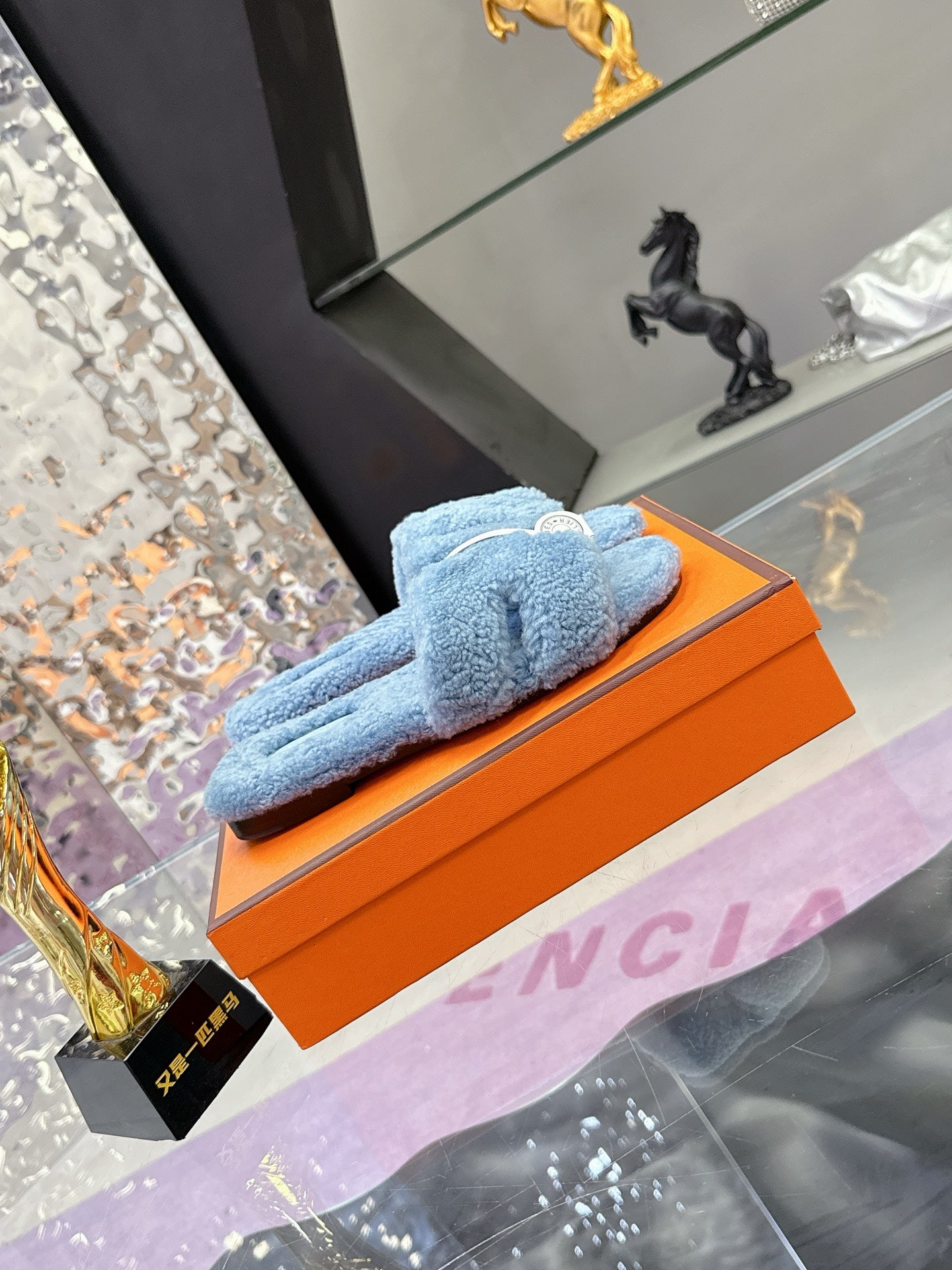 Hermes light blue plush slide sandals with white strap and round silver-tone emblem