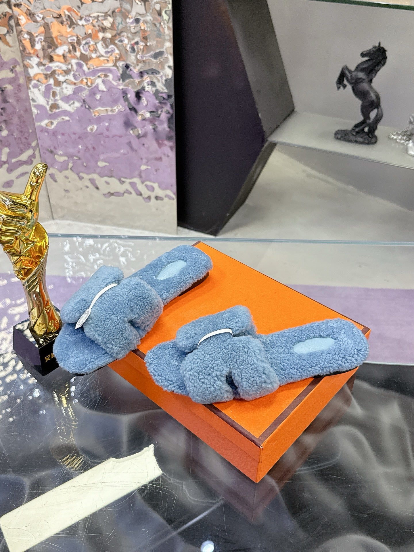 Hermes plush slip-on sandals in light blue with white strap detail and round emblem