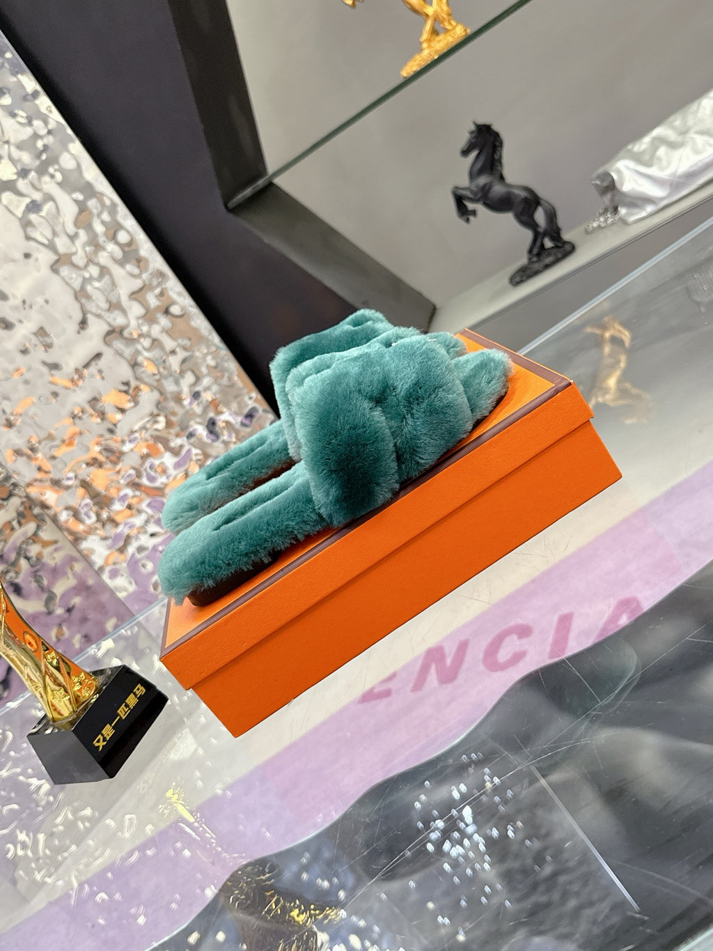 Hermes women’s teal plush slide sandals with bow strap and silver-tone ring charm