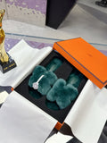 Hermes women’s teal plush slide sandals with bow and small silver logo buckle