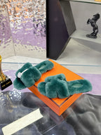 Hermes women’s teal plush bow slide sandals with white logo emblem on strap