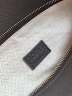 Loewe men's bag lining close-up with Loewe patch tag near zipper