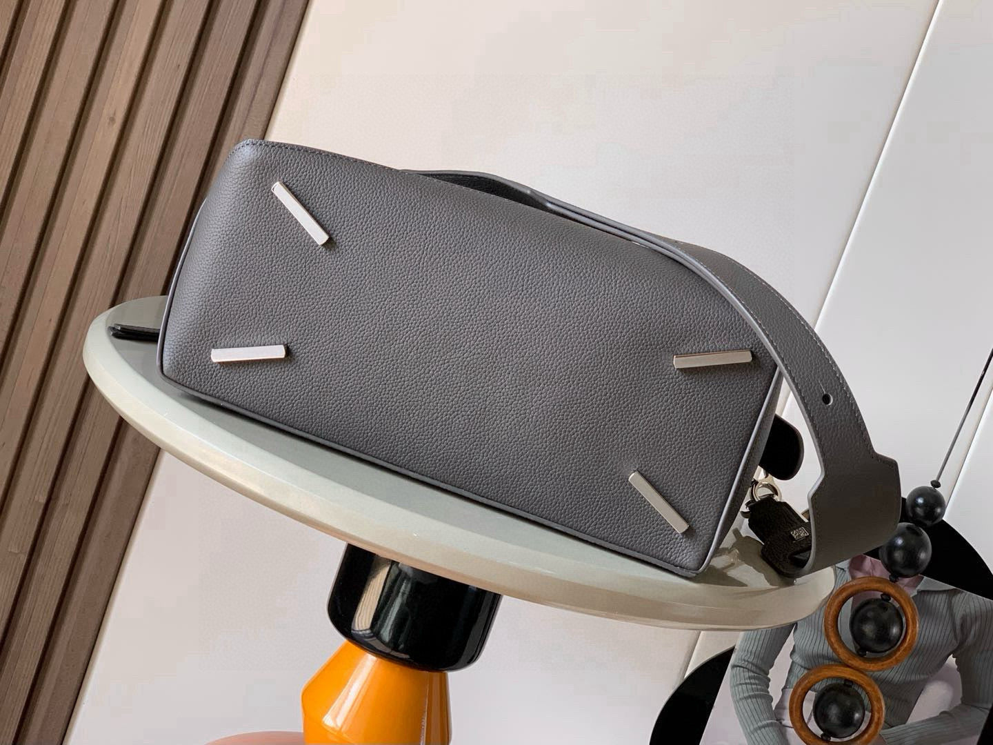 Loewe men's bag front view with top handle, flap, and silver corner hardware