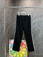 Black track pants with elastic waistband, drawstring, and colorful cartoon side print