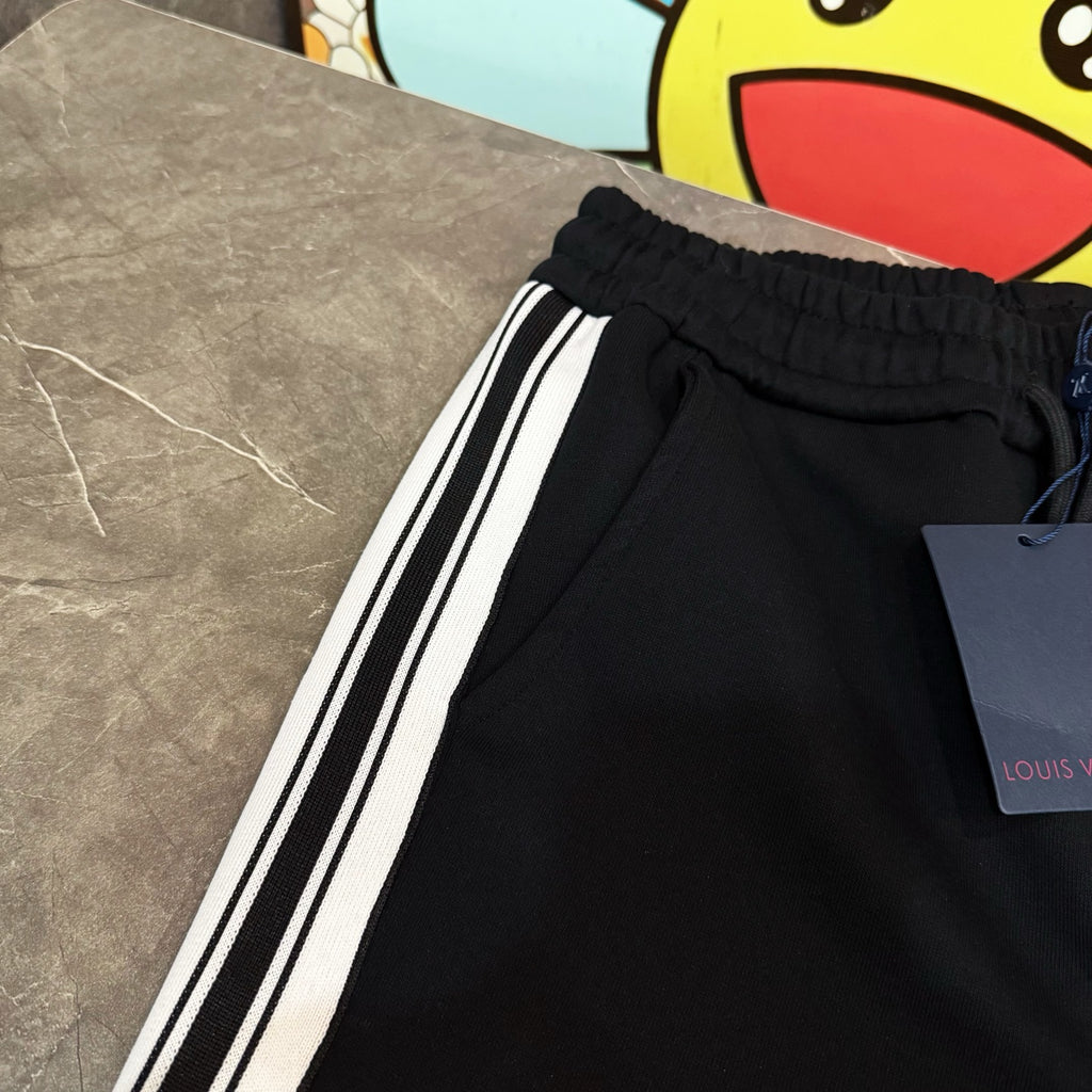 Black jogger pants with elastic waistband and white side stripes