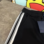 Black jogger pants with elastic waistband and white side stripes