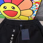 Louis Vuitton black jogger pants with elastic waistband and LV logo symbols