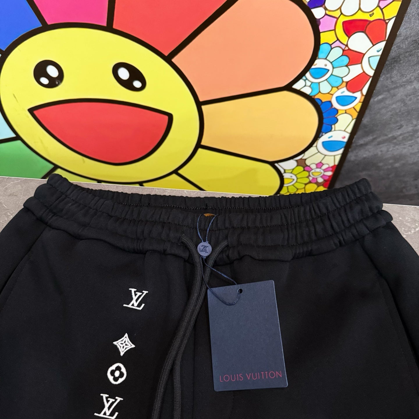 Louis Vuitton black jogger pants with elastic waistband and LV logo symbols