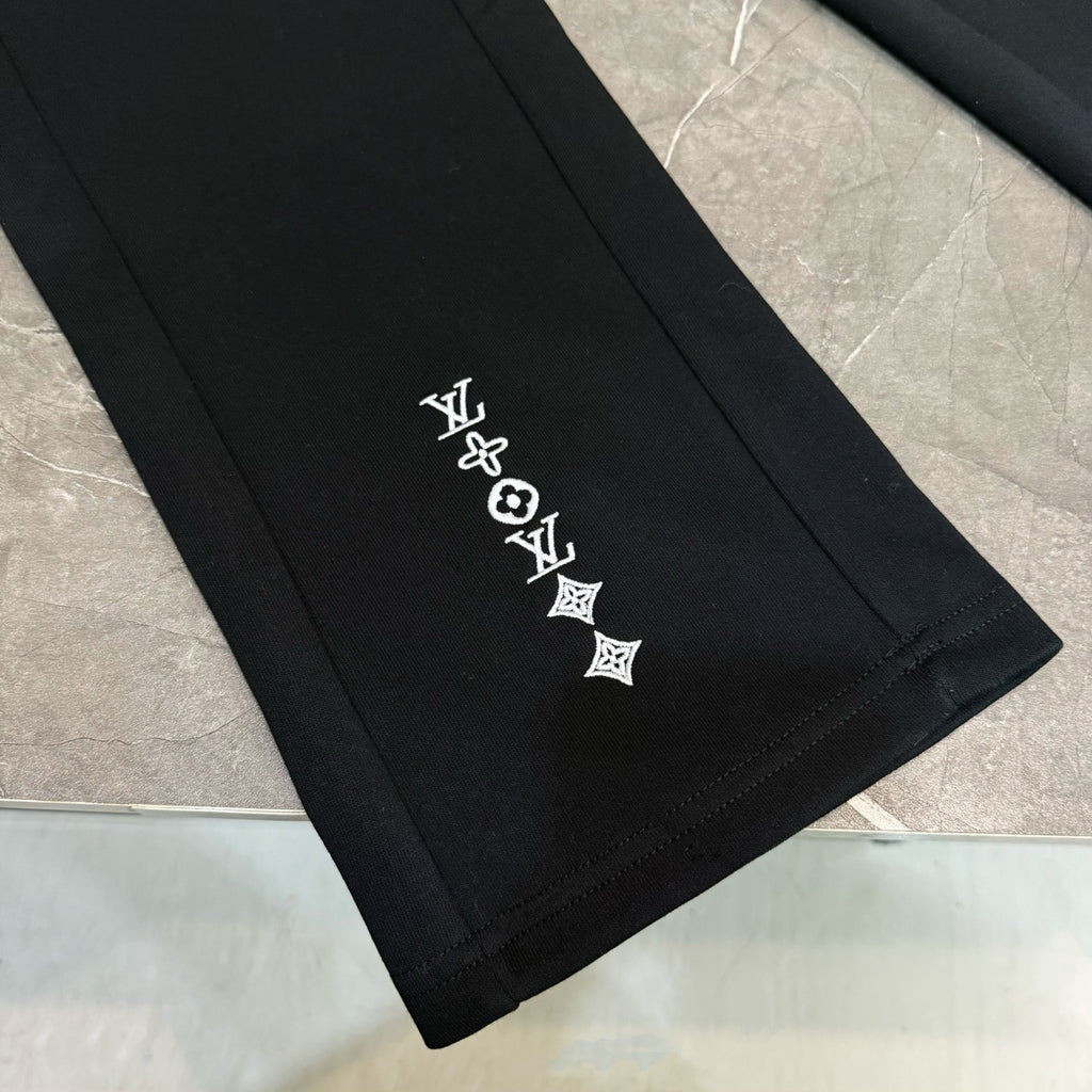Louis Vuitton black pants hem detail with white logo symbols