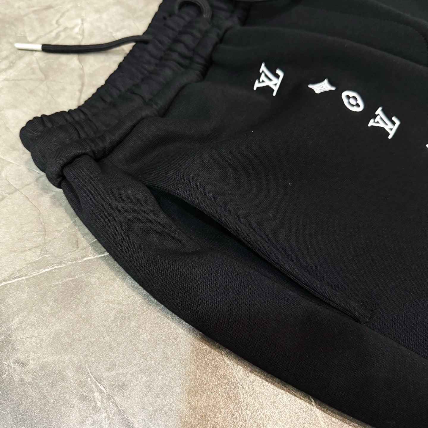 Louis Vuitton black pants with elastic cuff and logo graphics on thigh
