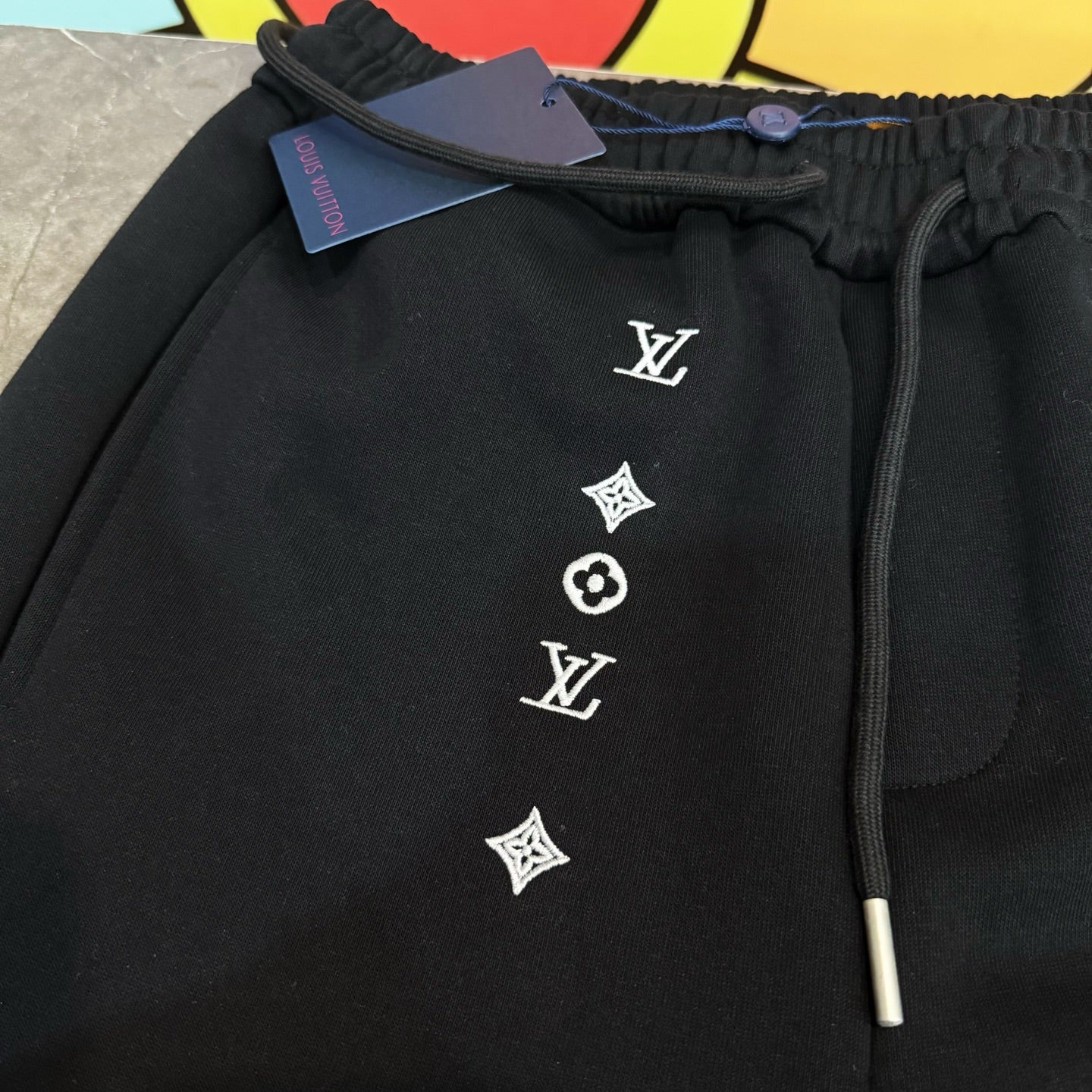 Louis Vuitton black drawstring pants with LV emblem and quatrefoil print