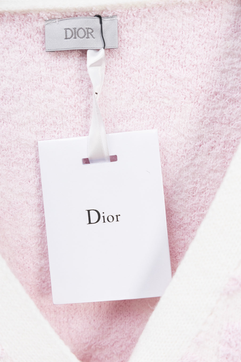 Dior pink textured cardigan with white neck trim and hanging tag