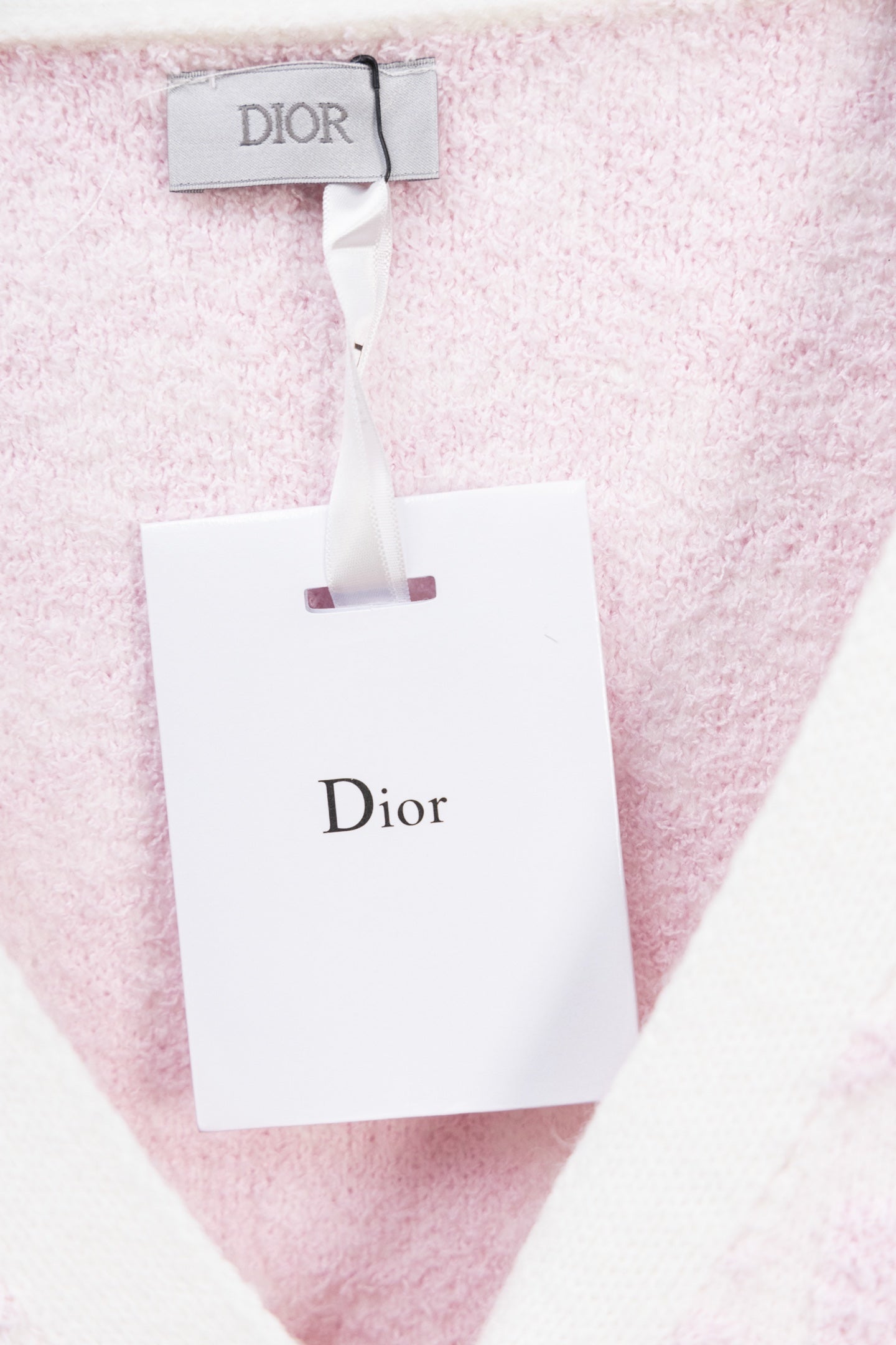 Dior pink textured cardigan with white neck trim and hanging tag