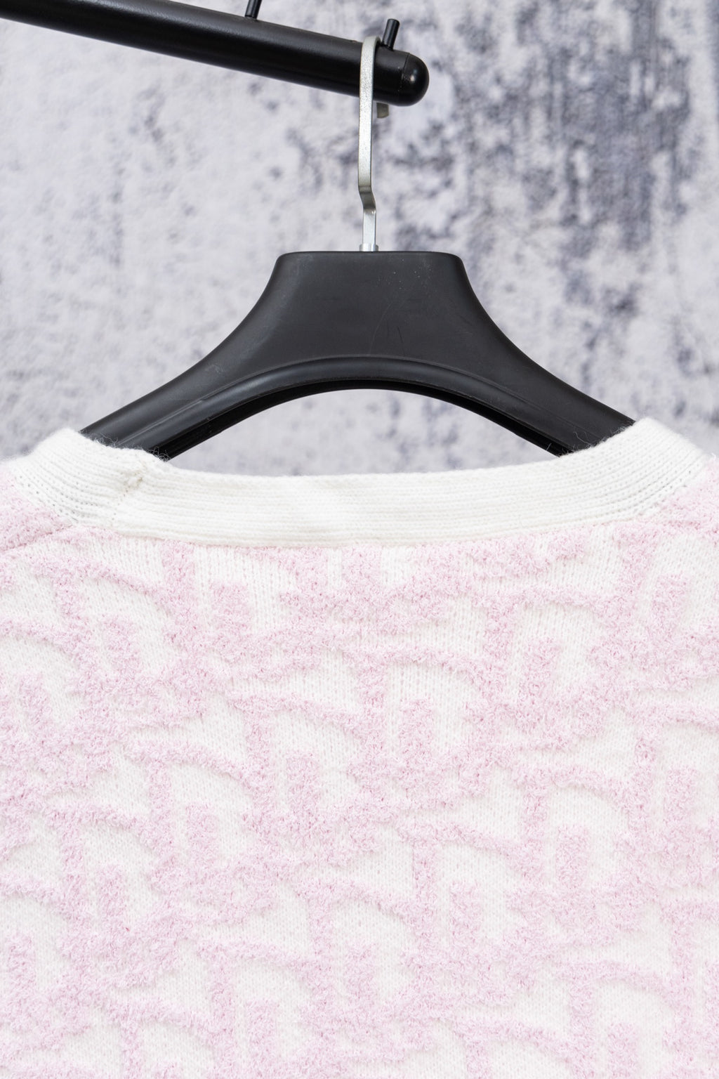 Pale pink textured knit cardigan back on hanger