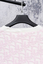 Pale pink textured knit cardigan back on hanger