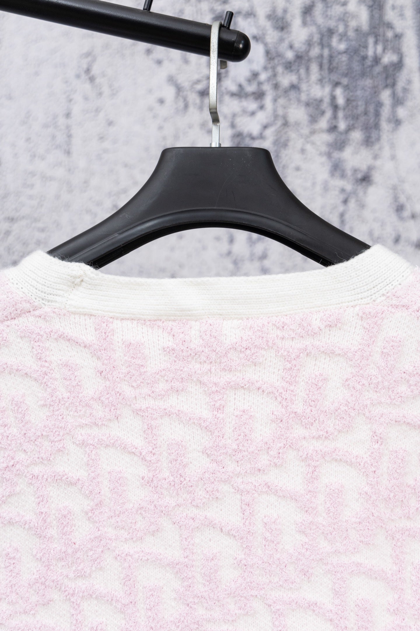 Pale pink textured knit cardigan back on hanger