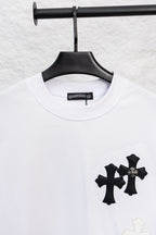 White crewneck T-shirt with three black cross appliques and a light cross