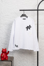 White long-sleeve T-shirt with black cross patch graphic on the chest