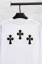 White long-sleeve T-shirt with large black cross appliques across the chest