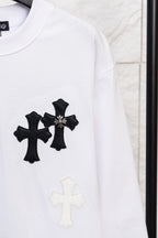 White long-sleeve T-shirt with black cross applique and small light cross below