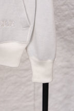 Dior monogram zip hoodie lower sleeve detail, white ribbed cuffs and hem