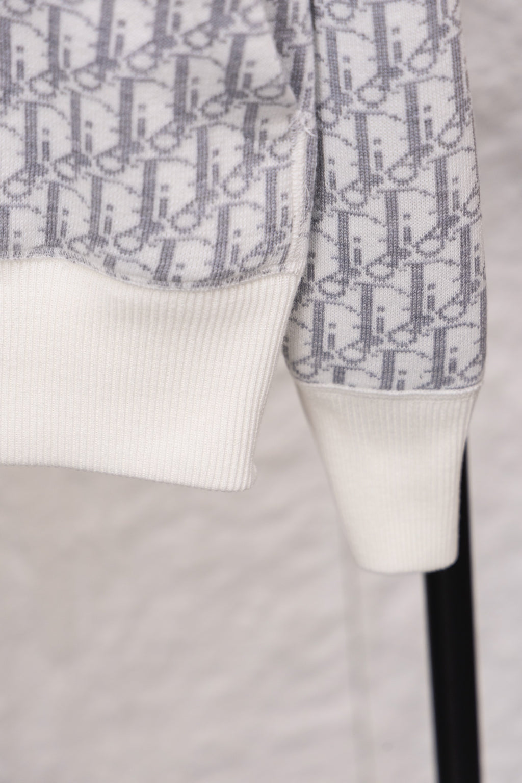 Dior monogram zip hoodie sleeve detail, patterned fabric with white cuff