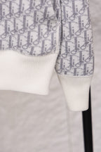 Dior monogram zip hoodie sleeve detail, patterned fabric with white cuff