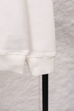 White sweatshirt cuff and hem with ribbed knit trim