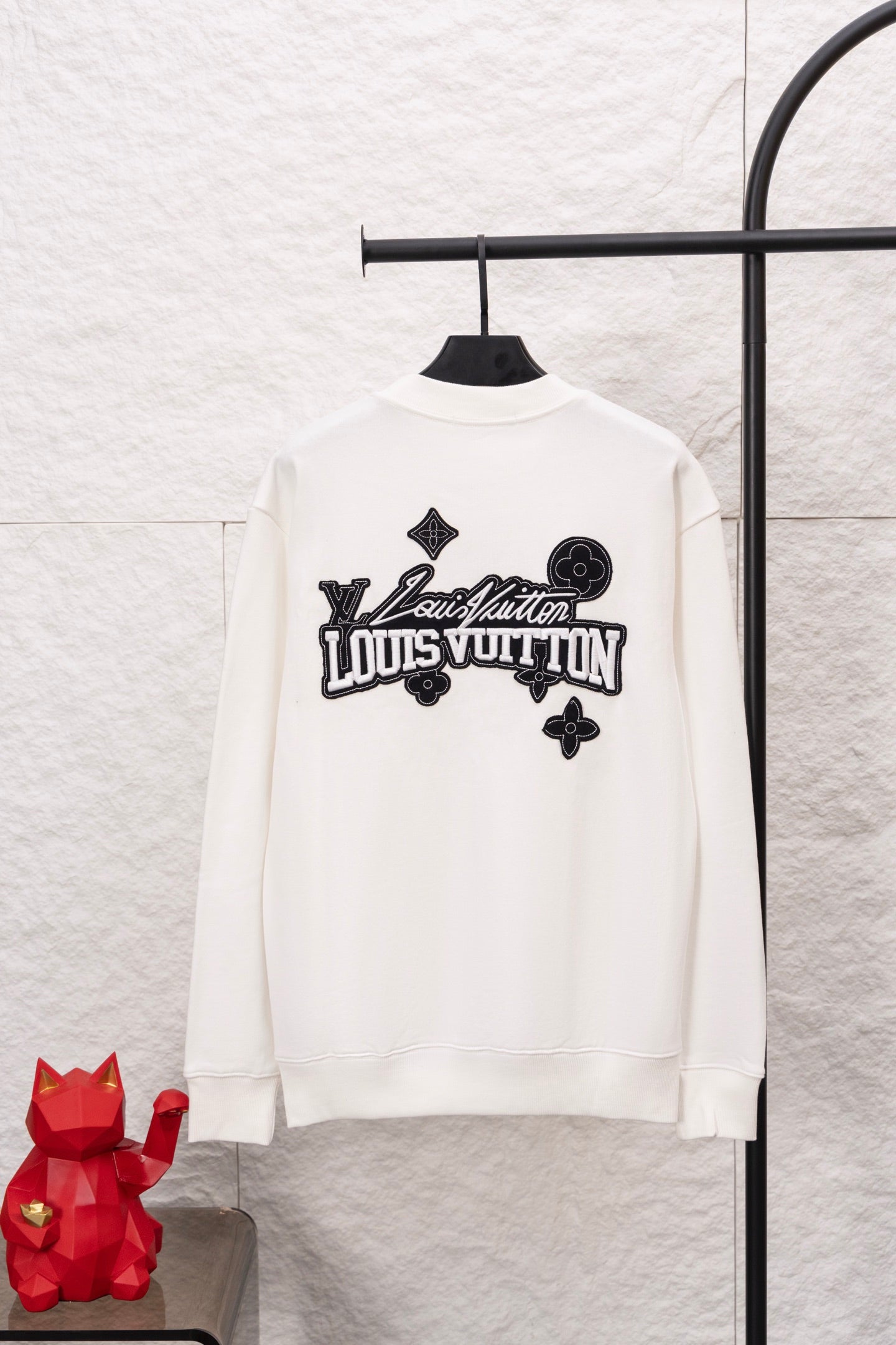White long-sleeve sweatshirt with large Louis Vuitton logo graphic on the back