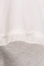 White sweatshirt hem with ribbed trim at the bottom