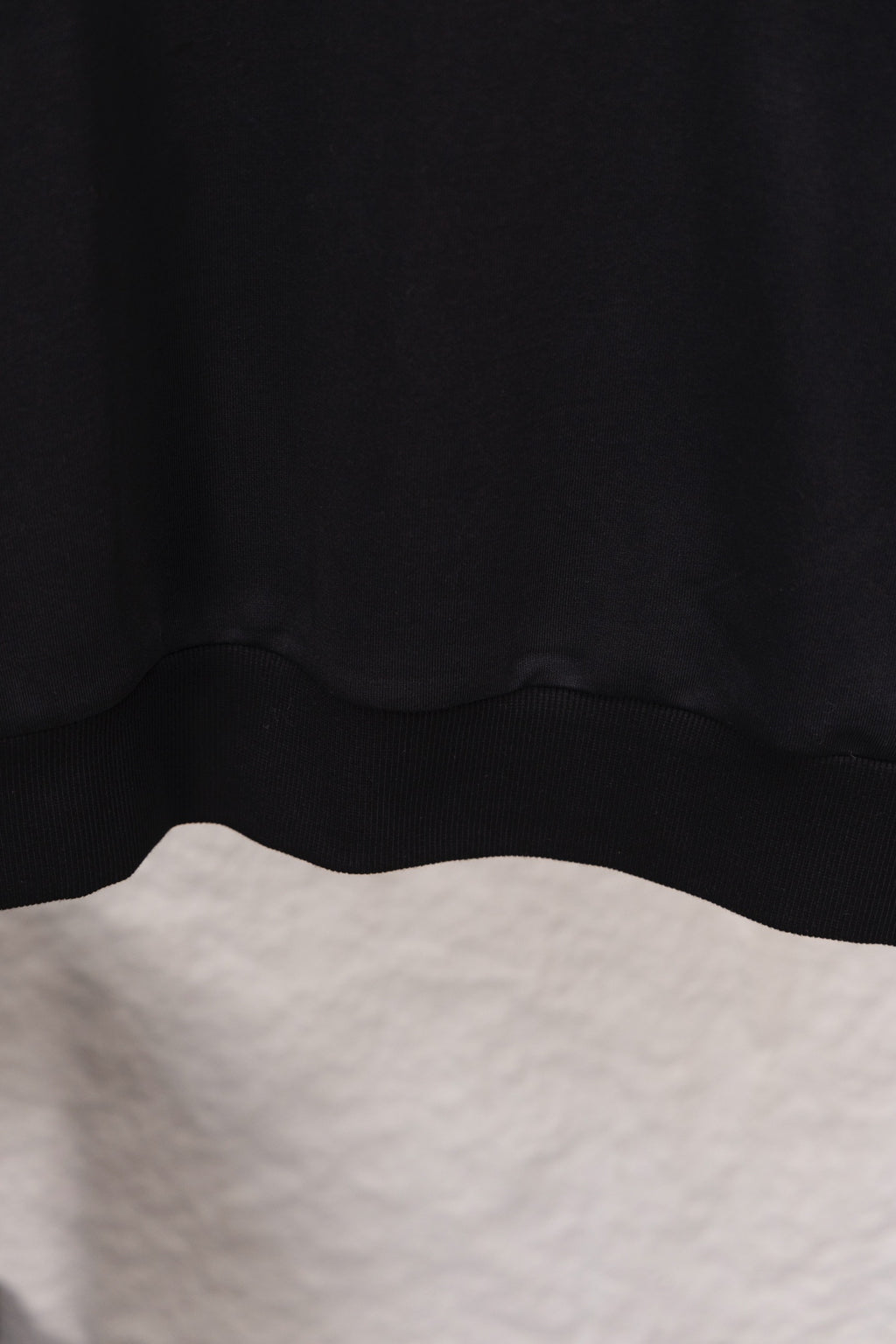Prada sweatshirt hem with ribbed waistband, close-up