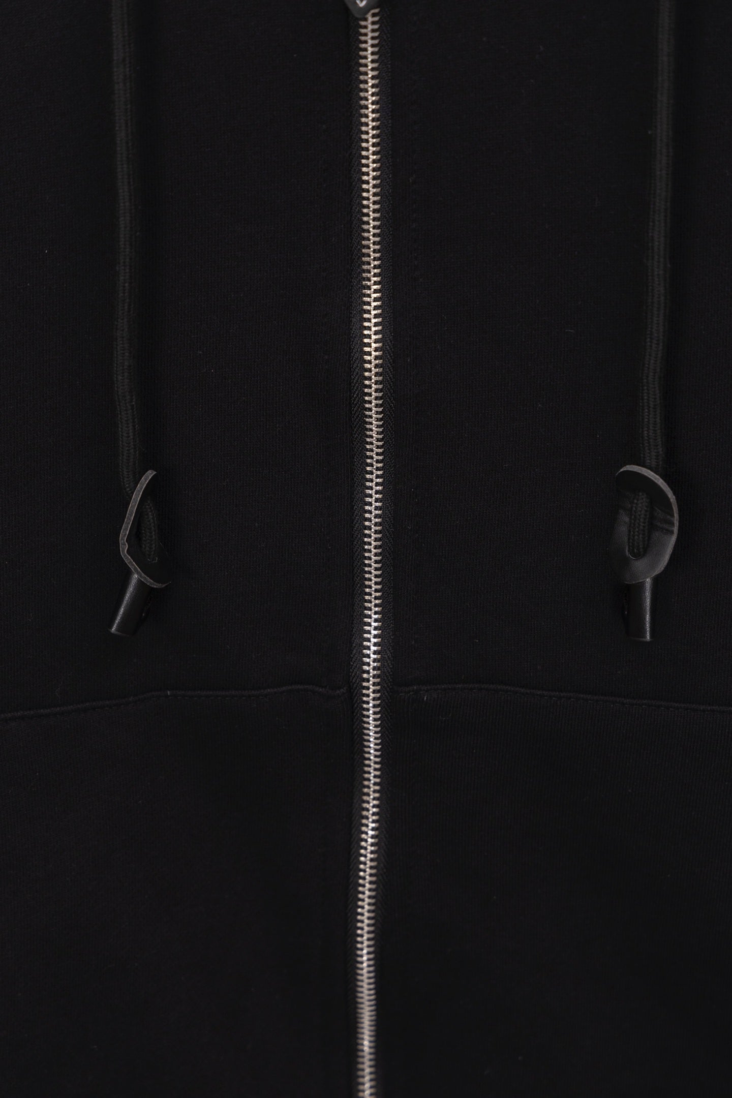 Black hoodie front close-up with zipper and drawstring details